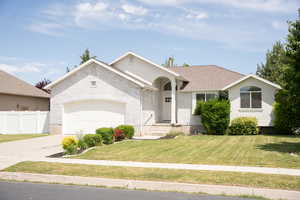 View of front of home with concrete driveway, a garage, and brick siding