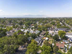 Aerial view of property and surrounding area with mountains and nearby suburban area