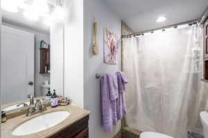 Bathroom featuring vanity and a shower stall