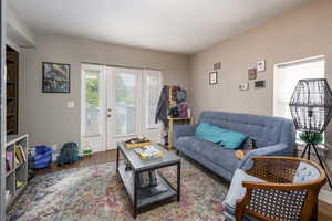 Living area with wood finished floors and baseboards