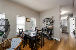 Dining room featuring hardwood / wood-style flooring and a textured ceiling