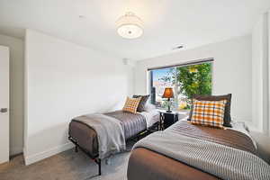 Bedroom featuring carpet floors and a textured ceiling