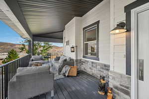 Wooden deck featuring a mountain view and an outdoor hangout area
