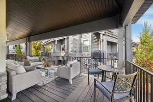 Wooden deck with outdoor lounge area and area for grilling
