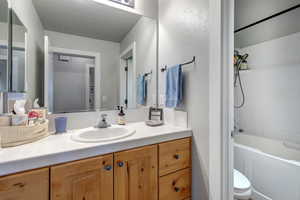 Bathroom featuring vanity, shower / bathtub combination