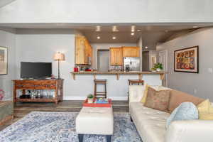 Living area featuring recessed lighting and dark wood finished floors