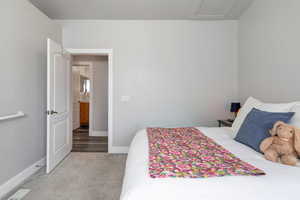 Second bedroom featuring light carpet