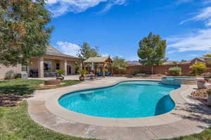 View of swimming pool with a patio, a pool with connected hot tub, a fenced backyard, and a gazebo