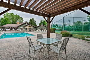 Community pool with a patio area and a pergola
