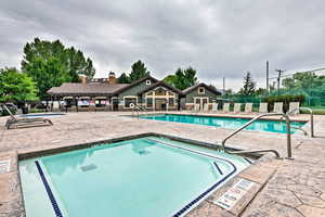 Community pool featuring a patio area and a hot tub