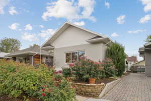 Back of property featuring brick siding and a gate