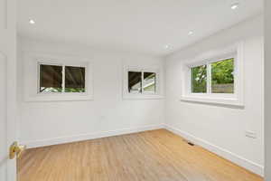 Unfurnished room featuring light wood-style floors and recessed lighting