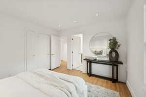 Bedroom featuring light wood-style floors, a closet, and recessed lighting