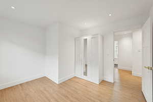 Empty room with recessed lighting and light wood-type flooring