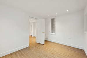 Spare room with light wood-type flooring and recessed lighting