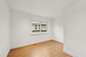 Unfurnished room featuring light wood-type flooring and recessed lighting