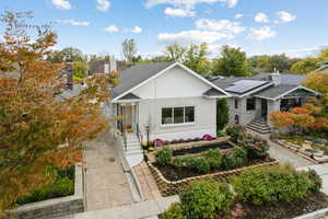 Ranch-style house featuring brick siding and roof with shingles