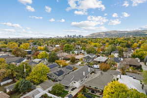 Aerial perspective of suburban area featuring skyline, a mountainous background, and property parcel outlined