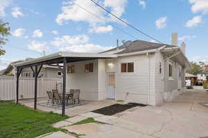 Rear view of property featuring a chimney, a patio area, and a gazebo