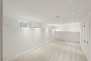 Unfurnished room with light carpet and recessed lighting