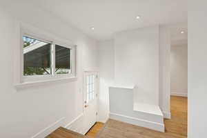 Foyer entrance featuring light wood-style flooring and recessed lighting