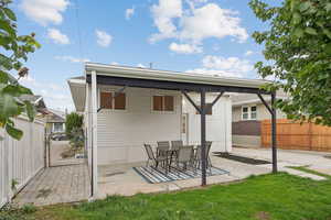 Back of property featuring a patio and a gate