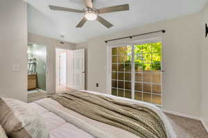 Bedroom featuring new carpet floors, access to outside, a ceiling fan, and ensuite bathroom
