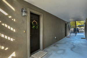 Property entrance featuring stucco siding