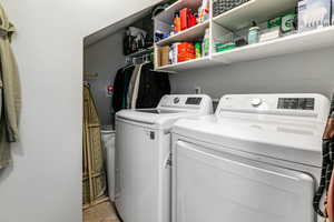 Laundry room with light tile patterned flooring