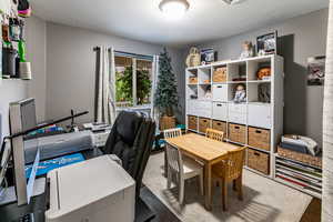 Carpeted bedroom with drapes and closet