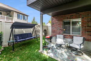 Private fenced backyard featuring a covered patio area and gate