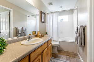 Full bath featuring tiled floor shower, jetted tub and vanity