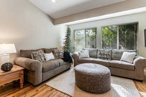 Living room with laminate wood finished floors and recessed lighting
