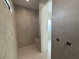 Bathroom featuring a tile shower and tile patterned floors