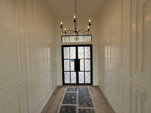 Entryway with a chandelier and french doors