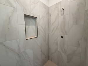 Full bathroom featuring tiled shower