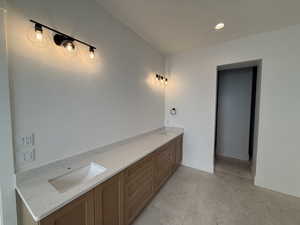 Bathroom with recessed lighting and double vanity