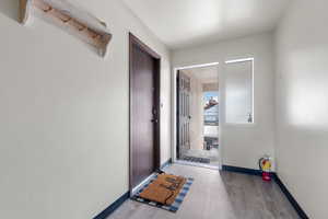 Corridor featuring wood finished floors and baseboards