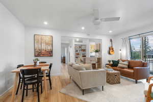 Living room featuring light wood-style flooring, recessed lighting, and ceiling fan