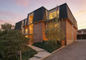 View of property at dusk