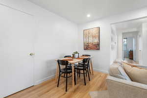 Dining space with light wood-type flooring and recessed lighting