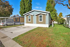 View of front of house featuring a front yard and concrete driveway