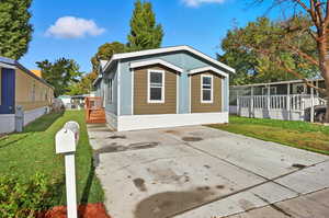View of side of home featuring a lawn