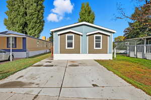 View of front of home with a front yard and driveway