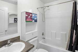 Full bath featuring shower / bath combo and vanity