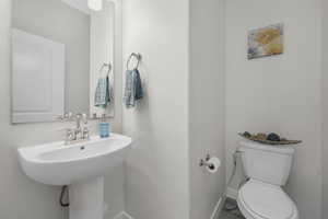 Bathroom with toilet and baseboards