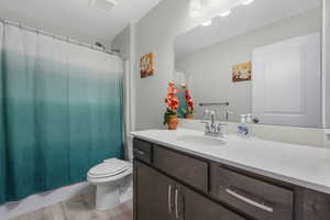 Bathroom with vanity, light wood finished floors, and shower / bathtub combination with curtain