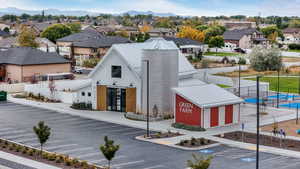 View of building exterior featuring uncovered parking and a residential view