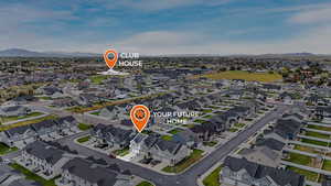 Aerial view of property and surrounding area featuring mountains and nearby suburban area