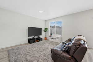 Living area featuring light wood-style floors and baseboards